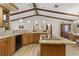 Kitchen with island, breakfast bar, light wood cabinetry, and unique ceiling beams at 22349 Columbus Ave, Port Charlotte, FL 33954