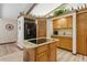 Kitchen featuring an island cooktop, ample cabinet space, and black refrigerator at 22349 Columbus Ave, Port Charlotte, FL 33954