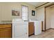 This laundry room features modern appliances, granite countertops and wood-look cabinets at 22349 Columbus Ave, Port Charlotte, FL 33954