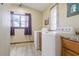 This laundry room features modern appliances and a window with a beautiful sky view at 22349 Columbus Ave, Port Charlotte, FL 33954