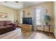 This living room features wood-look floors, sofa, a flat screen TV and large windows at 22349 Columbus Ave, Port Charlotte, FL 33954