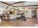 Bright living room featuring vaulted ceilings with exposed beams and modern exercise equipment at 22349 Columbus Ave, Port Charlotte, FL 33954