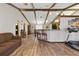Open living room with exposed beam vaulted ceilings and hardwood floors that leads to kitchen at 22349 Columbus Ave, Port Charlotte, FL 33954