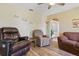 Relax in this living room with wood-look floors, recliner chairs, and 'Live, Laugh, Love' wall decor at 22349 Columbus Ave, Port Charlotte, FL 33954
