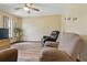 A cozy living room with wood-look flooring, recliner chairs, and a flat-screen TV at 22349 Columbus Ave, Port Charlotte, FL 33954