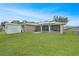 This large backyard has a shed, lanai and solar panels on the roof at 22353 Blanchard Ave, Port Charlotte, FL 33952