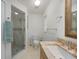Bathroom featuring a granite countertop vanity, walk-in shower, and tiled floors at 22353 Blanchard Ave, Port Charlotte, FL 33952