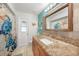 Bathroom with a granite countertop vanity, a shower with a curtain, and themed decor at 22353 Blanchard Ave, Port Charlotte, FL 33952
