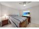 Cozy bedroom with tile floors, ceiling fan, and a TV with beach scene at 22353 Blanchard Ave, Port Charlotte, FL 33952