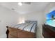 Bedroom featuring tile floors, ceiling fan, a TV with beach scene and nice dark furniture at 22353 Blanchard Ave, Port Charlotte, FL 33952