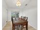 Bright dining area with hardwood floors, a stylish light fixture, and outdoor views at 22353 Blanchard Ave, Port Charlotte, FL 33952