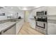 Updated kitchen with granite countertops, stainless steel appliances, and white cabinetry at 22353 Blanchard Ave, Port Charlotte, FL 33952