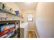 Laundry room with window, washer, dryer, shelving and wood look flooring at 22353 Blanchard Ave, Port Charlotte, FL 33952