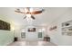 Bright living room with wood floors, high ceilings, fan, and artwork on display at 22353 Blanchard Ave, Port Charlotte, FL 33952