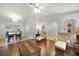 Spacious living area with hardwood floors, ceiling fan, and dining area with sliding glass doors at 22353 Blanchard Ave, Port Charlotte, FL 33952