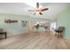 Bright, open living space with hardwood floors, bar seating, and an open-concept kitchen at 22353 Blanchard Ave, Port Charlotte, FL 33952