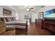 Bedroom with striped bedding, ceiling fan, wood floors, dresser, and door to the backyard at 22353 Blanchard Ave, Port Charlotte, FL 33952