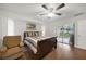 Bedroom featuring a ceiling fan, striped bedding, and a sliding glass door to the outside at 22353 Blanchard Ave, Port Charlotte, FL 33952
