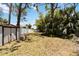 Spacious backyard featuring a white privacy fence and mature trees for added shade and seclusion at 233 N New York Ave, Englewood, FL 34223