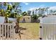 Backyard of the home with a yellow house and a banana tree in the yard at 233 N New York Ave, Englewood, FL 34223