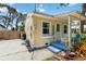 Charming yellow cottage with a small porch, concrete parking area and flamingo lawn art at 233 N New York Ave, Englewood, FL 34223