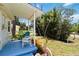 View of a cozy front porch with comfortable seating, plants and a blue painted deck at 233 N New York Ave, Englewood, FL 34223