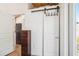 Hallway with sliding closet door and doorway with view to the stainless steel refrigerator at 233 N New York Ave, Englewood, FL 34223