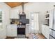 Bright kitchen features stainless appliances, subway tile backsplash, and wooden ceiling detail at 233 N New York Ave, Englewood, FL 34223