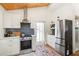 Bright kitchen features stainless appliances, subway tile backsplash, and wooden ceiling detail at 233 N New York Ave, Englewood, FL 34223