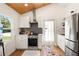 Bright kitchen features stainless appliances, subway tile backsplash, and wooden ceiling detail at 233 N New York Ave, Englewood, FL 34223