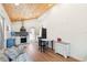 Open-concept living space with wood floors, vaulted wood ceiling, leading to the kitchen at 233 N New York Ave, Englewood, FL 34223