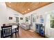 Living room with vaulted ceilings, wood detail, and dining area at 233 N New York Ave, Englewood, FL 34223
