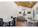 Bright and airy living room with wood floors, vaulted wood ceiling, and comfortable seating at 233 N New York Ave, Englewood, FL 34223
