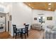 Cozy living room with wood floors, vaulted ceilings, and dining area at 233 N New York Ave, Englewood, FL 34223