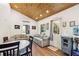 Bright living room with wood floors, wood ceiling, comfortable seating and adjacent kitchen at 233 N New York Ave, Englewood, FL 34223