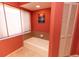 Bathroom featuring a soaking tub and a window for natural light at 238 Mark Twain Ln, Rotonda West, FL 33947