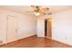 Bedroom has wood-look floors, interior doors, and a ceiling fan with lights at 238 Mark Twain Ln, Rotonda West, FL 33947
