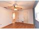 Bedroom with wood-look floors, ceiling fan, and interior doors with white walls at 238 Mark Twain Ln, Rotonda West, FL 33947