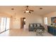 Bright living room features tile flooring, ceiling fan and access to the pool at 238 Mark Twain Ln, Rotonda West, FL 33947