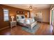 Main bedroom featuring wood floors, a ceiling fan and lots of natural light at 238 Mark Twain Ln, Rotonda West, FL 33947