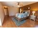 Spacious main bedroom featuring wood floors, ceiling fan and plenty of light at 238 Mark Twain Ln, Rotonda West, FL 33947
