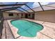 Enjoy the Florida sunshine in this screened-in pool with a brick surround at 238 Mark Twain Ln, Rotonda West, FL 33947