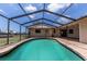 Relax in this pool with enclosure, steps, and brick surround to enjoy outdoor living at 238 Mark Twain Ln, Rotonda West, FL 33947