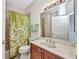 Bathroom featuring a vanity with wood cabinets, a white countertop, and a shower with a green coral shower curtain at 24312 Westgate Blvd, Port Charlotte, FL 33980