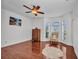 Bright bedroom boasts hardwood floors, a ceiling fan, and a bay window that fills the room with natural light at 24312 Westgate Blvd, Port Charlotte, FL 33980