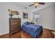 Comfortable bedroom with a dark wood dresser, stylish decor, and a plush blue quilt on the inviting bed at 24312 Westgate Blvd, Port Charlotte, FL 33980