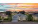 Charming single-story home boasts a well-manicured lawn and a picturesque sunset backdrop at 24312 Westgate Blvd, Port Charlotte, FL 33980