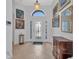 Bright entryway with decorative glass door, tiled floor, and elegant decor at 24312 Westgate Blvd, Port Charlotte, FL 33980
