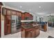 Bright eat-in kitchen with stainless steel appliances, granite counters, and a central island at 24312 Westgate Blvd, Port Charlotte, FL 33980