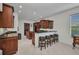 Eat-in kitchen features wood cabinetry, granite countertops, breakfast bar, and modern appliances at 24312 Westgate Blvd, Port Charlotte, FL 33980